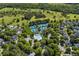 Aerial view featuring community pool, tennis courts, lush greenery, and attractive homes at 4862 Tarry Post Ln, Suwanee, GA 30024