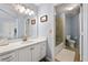 Bathroom featuring a shower/tub combo, white vanity, tile floors and updated fixtures at 4862 Tarry Post Ln, Suwanee, GA 30024