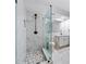 Bright bathroom with modern glass shower, stone pebble floor, marble tile and updated vanity at 4862 Tarry Post Ln, Suwanee, GA 30024