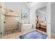 Bathroom with walk-in shower, soaking tub, stained-glass window, and neutral color palette at 4862 Tarry Post Ln, Suwanee, GA 30024