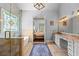Bathroom with walk-in shower, soaking tub, vanity and stained-glass window at 4862 Tarry Post Ln, Suwanee, GA 30024