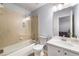 Neutral bathroom featuring glass shower door, tile surround, white vanity and updated fixtures at 4862 Tarry Post Ln, Suwanee, GA 30024