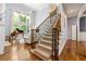 Grand foyer with a staircase, hardwood floors, and a soaring two-story window providing natural light at 4862 Tarry Post Ln, Suwanee, GA 30024