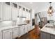 Beautiful white kitchen featuring granite countertops, stainless steel appliances, and ample cabinet space at 4862 Tarry Post Ln, Suwanee, GA 30024