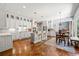 Open concept kitchen with white cabinets, granite countertops, stainless steel appliances, and a view to the living area at 4862 Tarry Post Ln, Suwanee, GA 30024