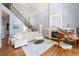 Spacious living room with a fireplace, piano, hardwood floors, and staircase at 4862 Tarry Post Ln, Suwanee, GA 30024