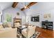 Bright living room featuring vaulted ceilings, fireplace, hardwood floors, and ample seating at 4862 Tarry Post Ln, Suwanee, GA 30024
