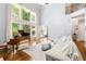 Bright living room featuring hardwood floors, a piano, large windows, and a comfortable white sofa at 4862 Tarry Post Ln, Suwanee, GA 30024