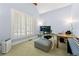 Bright and airy home office with a vaulted ceiling, plantation shutters, and comfortable furnishings at 4862 Tarry Post Ln, Suwanee, GA 30024