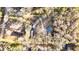 Aerial view showcasing the property, boundaries, surrounding trees, and multiple structures at 5520 Hearn Rd, Ellenwood, GA 30294