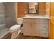 Bathroom featuring a glass-door shower, granite countertop vanity, and wood-paneled walls at 5520 Hearn Rd, Ellenwood, GA 30294