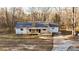 Charming single-story home with a wooden porch and mature trees in the yard at 5520 Hearn Rd, Ellenwood, GA 30294