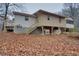 View of the rear of a home with a deck and stairs, showing the exterior of the partially finished basement at 5520 Hearn Rd, Ellenwood, GA 30294