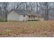 Charming one story home featuring a covered porch and surrounded by a wooded area at 5520 Hearn Rd, Ellenwood, GA 30294