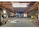 Spacious garage interior with auto lifts, and fluorescent lighting at 5520 Hearn Rd, Ellenwood, GA 30294