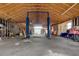 Interior view of a large garage with a high ceiling and auto lifts at 5520 Hearn Rd, Ellenwood, GA 30294