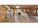 Bright, open kitchen featuring white cabinetry, stainless steel appliances, and hardwood flooring at 5520 Hearn Rd, Ellenwood, GA 30294