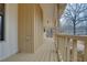 Side porch featuring wood flooring and railings, extending the living space outdoors with natural surroundings at 5520 Hearn Rd, Ellenwood, GA 30294