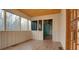 Bright sunroom with large windows offering scenic views and access to other rooms at 5520 Hearn Rd, Ellenwood, GA 30294