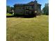 Large grassy backyard, perfect for outdoor activities, leading to a peaceful wooded area at 220 Cameron Ways, Covington, GA 30016