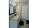Bathroom features a double vanity with granite countertops and stylish fixtures at 220 Cameron Ways, Covington, GA 30016