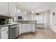 Modern kitchen with white cabinets, granite countertops, and stainless steel appliances at 220 Cameron Ways, Covington, GA 30016
