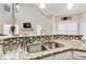 Open kitchen with granite counters, stainless steel appliances, and a breakfast bar at 220 Cameron Ways, Covington, GA 30016