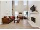 Bright living room features a fireplace, high ceilings, and comfortable seating at 220 Cameron Ways, Covington, GA 30016