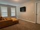 Inviting living room featuring large windows, comfortable seating, and cozy carpet at 220 Cameron Ways, Covington, GA 30016