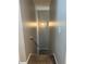 Neutral paint in a home's stairwell with a light fixture and carpeted stairs at 220 Cameron Ways, Covington, GA 30016