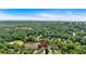 Aerial view of a beautiful property nestled among lush trees overlooking a serene lake under a clear blue sky at 4508 Club House Dr, Marietta, GA 30066