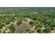 Overhead view of a neighborhood community pool, tennis courts, and lake surrounded by lush trees and well-maintained homes at 4508 Club House Dr, Marietta, GA 30066