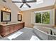 Bright bathroom featuring a soaking tub, skylight, and a double sink vanity at 4508 Club House Dr, Marietta, GA 30066