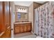 Cozy bathroom features a granite countertop, wood cabinets, and a shower at 4508 Club House Dr, Marietta, GA 30066