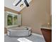 Bright bathroom featuring a soaking tub, skylight, and modern tile flooring at 4508 Club House Dr, Marietta, GA 30066
