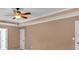 Bedroom featuring a tray ceiling, ceiling fan, and neutral colored walls at 4508 Club House Dr, Marietta, GA 30066