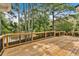 A spacious wooden deck with black railings offers stunning views of the serene lake at 4508 Club House Dr, Marietta, GA 30066