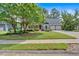Charming brick home with a well-manicured lawn and mature trees at 4508 Club House Dr, Marietta, GA 30066