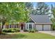 Charming brick home with well-maintained lawn, mature trees, and two-car garage at 4508 Club House Dr, Marietta, GA 30066