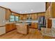 Updated kitchen with a central island, stainless steel appliances, granite countertops, and hardwood floors at 4508 Club House Dr, Marietta, GA 30066