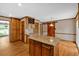 Open kitchen with granite island, custom cabinets, wine rack, and stainless sink with updated fixtures at 4508 Club House Dr, Marietta, GA 30066