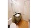 Cozy bathroom with laminate floors, single sink vanity, and toilet at 4590 Galleon Xing, Decatur, GA 30035