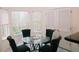 Cozy breakfast nook with glass table surrounded by four chairs and three windows for natural light at 4590 Galleon Xing, Decatur, GA 30035
