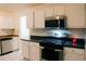 Well-equipped kitchen features modern stainless steel appliances and white cabinetry with contrasting countertops at 4590 Galleon Xing, Decatur, GA 30035