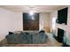 Inviting living room with a large sectional sofa, a wall-mounted TV, and a cozy fireplace at 4590 Galleon Xing, Decatur, GA 30035