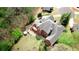 Aerial view of the luxury home situated in a lush, wooded landscape with backyard amenities at 4799 Winterview Ln, Douglasville, GA 30135