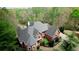 An aerial view showcases the home's roofline, landscaping, and the surrounding trees, creating a private setting at 4799 Winterview Ln, Douglasville, GA 30135
