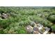 An aerial view displays a neighborhood surrounded by lush trees, showcasing the tranquil environment and beautiful homes at 4799 Winterview Ln, Douglasville, GA 30135