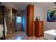Bathroom with large shower, checkered tile, and wooden cabinets at 4799 Winterview Ln, Douglasville, GA 30135