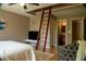 Bedroom featuring a unique loft access ladder, ensuite, and neutral paint scheme at 4799 Winterview Ln, Douglasville, GA 30135